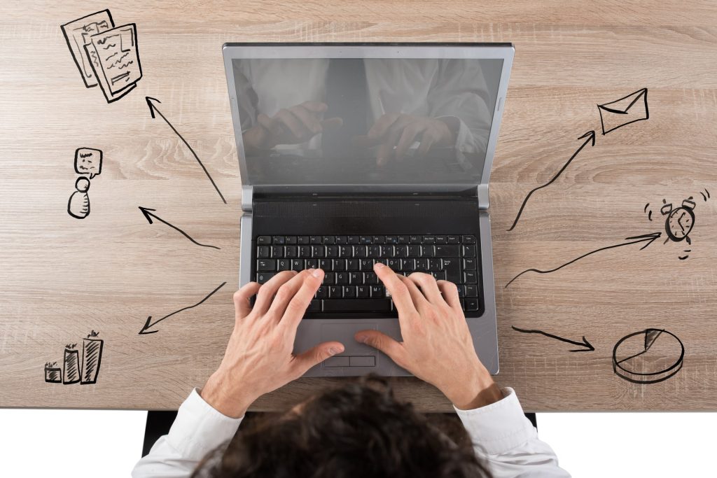 Businessman working at the computer to his projects simultaneously.