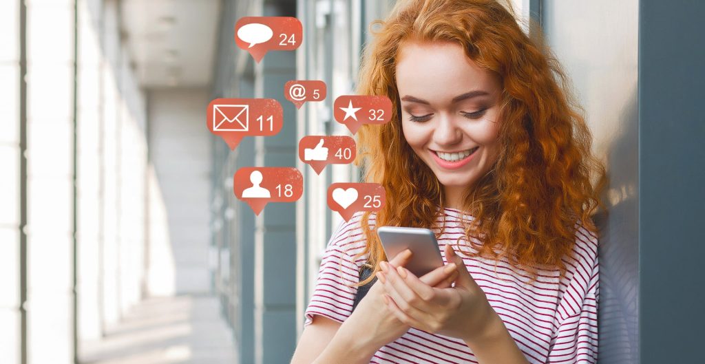 Blogger using phone with social media notification icons, panorama.