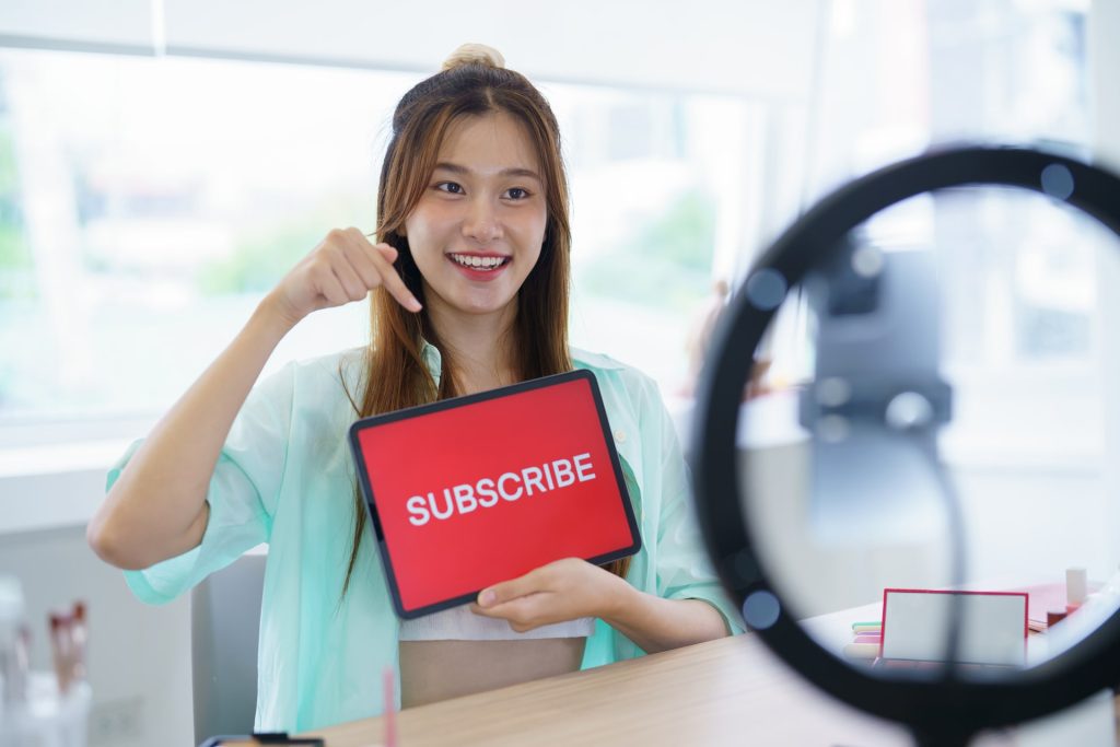 Online marketing Beauty influencer Asian girl Using Social Media for live streaming on Smartphone online audience like and subscribe to her channel. Like Follower.